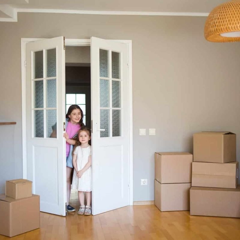 Children-Look-Into-Its-New-Home-Moving-To-Apartment-Boxes-In-House-1-1.Jpg