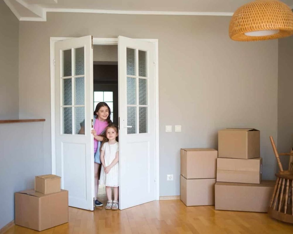 Children-Look-Into-Its-New-Home-Moving-To-Apartment-Boxes-In-House-1-1.Jpg